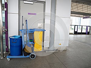 Cleaning tools cart wait for maid or cleaner in the subway train station. Bucket and set of cleaning equipment in the subway. Co