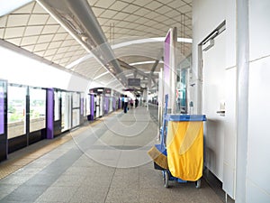 Cleaning tools cart wait for maid or cleaner in the subway train station. Bucket and set of cleaning equipment in the subway. Co