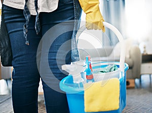 Cleaning tools, living room and maid hands of a woman in a house with chemical spray in basket. Home, cleaner and house