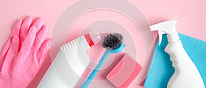 Cleaning tools and supplies on pink background. House cleaning service and housekeeping concept. Flat lay, top view