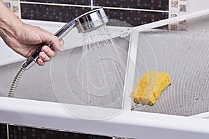 cleaning and washing dusty mosquito net screen for window. housework concept