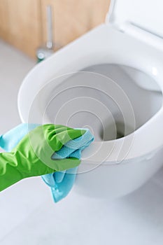 Cleaning the white toilet seat in the lavatory photo