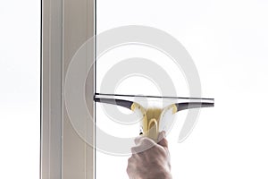 Cleaning windows with electric vacuum cleaner. Spring house cleaning- image.Window washing with a vacuum cleaner.hand