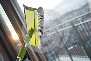 Cleaning windows with a squeegee.