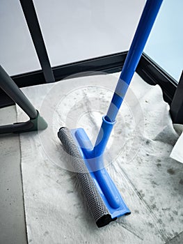 Cleaning windows with squeegee during spring cleaning