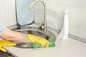 Cleaning. woman gloves hands cleaning kitchen sink. Cleaning home table, sanitizing kitchen table, surface with disinfectant spray