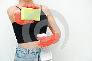 Cleaning woman with red rubber gloves on a white background. Young woman with sponge and spray bottle