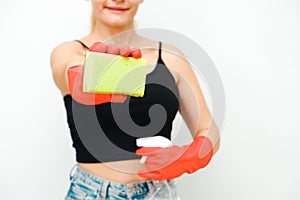 Cleaning woman with red rubber gloves on a white background. Young woman with sponge and spray bottle