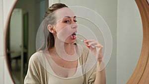 Cleaning a woman's teeth in the bathroom for oral hygiene. Mouth, dentist and dental office with an attractive young