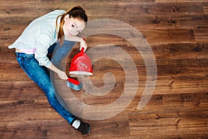 Cleaning woman sweeping wooden floor