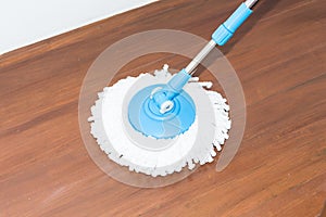 Cleaning wood floor by modern mop.