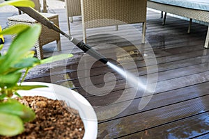 Cleaning wooden terrace planks with high pressure washer