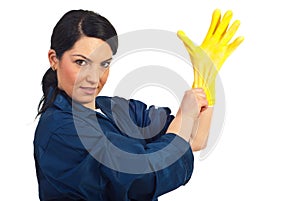 Cleaning worker woman puts protective glove