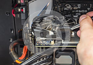 Cleaning your computer. Computer maintenance. Cleaning a dirty computer from dust with a special brush close-up. Place