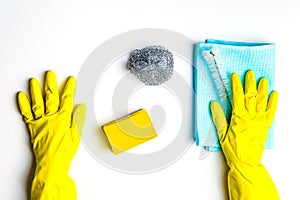 cleanliness and cleaning. rag, sponge and brush. females hands in yellow gloves