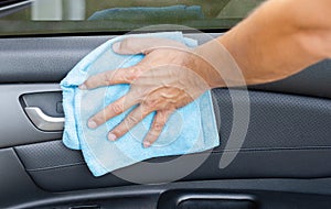 Cleansing car interior and door. Male hand  disinfecting vihicle inside