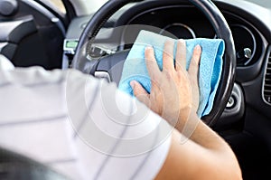 Cleansing car interior. Male hand  disinfecting vihicle inside