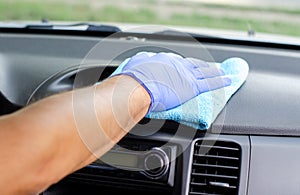 Cleansing car interior. Male hand  in protective glove disinfecting vihicle inside