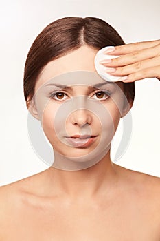 Cleansing face wasing tonic. Demakeup. remove mascara. Cotton pad hand photo