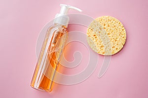 Cleansing oil for the face or cleansing gel with oils. skin cleaning, makeup removal, facial cleanser, washing, pink background.