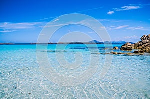 Clear amazing azure coloured sea water with granite rocks in Capriccioli beach, Sardinia, Italy