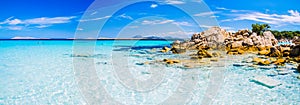 Clear amazing azure coloured sea water with gtanote rocks in Capriccioli beach, Sardinia, Italy