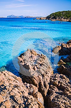 Clear amazing azure coloured sea water with gtanote rocks in Capriccioli beach, Sardinia, Italy