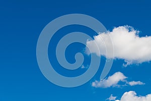 Clear azure blue sky background with group of romantic puffy white clouds