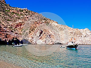 A clear bay and the lighthouse of Polyaigos, an island of the Greek Cyclades