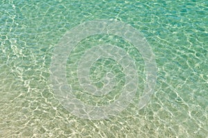 Clear beach ripple water reflecting in the sun