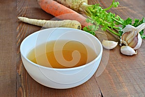 Clear beef broth, bone broth, bouillon in white bowl