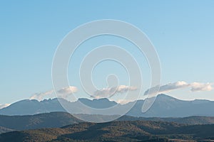 clear blue air over mountains in bulgaria crops hay fields clouds blue sharp focus distance superzoom copy space for text minimal