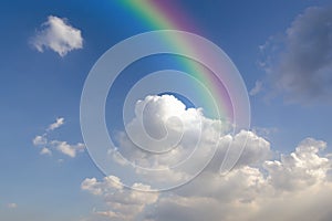 Clear blue sky with white cloud with rainbow
