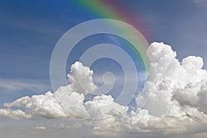 Clear blue sky with white cloud with rainbow