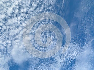 Clear blue sky with white fluffy clouds. Abstract nature background