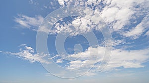 Clear blue sky with white fluffy clouds at noon. Day time. Abstract nature landscape background