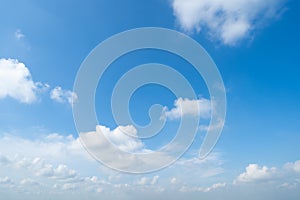 Clear blue sky with white fluffy clouds in summer season at noon time. Abstract nature background