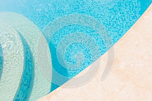 Clear blue water in the pool. Part of the pool closeup. Step int