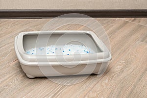 Clear Cat litter box on tile floors side view