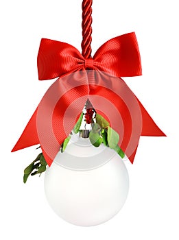 Clear Christmas ornament hanging from shiny red ribbon and bow with bright green mistletoe. Empty space in bauble for text or