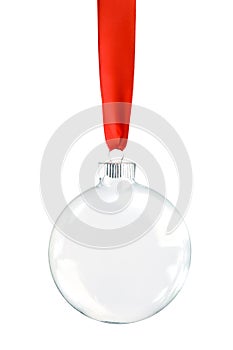 Clear Christmas ornament hanging from shiny red ribbon. Empty space in bauble for text or product. Isolated on white