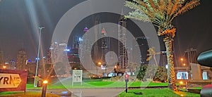 Clear and clean grace imege golf club Dubai in night time background sky tuch Building and deats tree