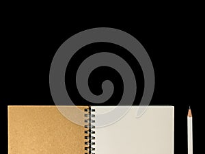 Clear color note book opened for note or lecture note or memo for remine and brown cover whit black head color pencil in white ap
