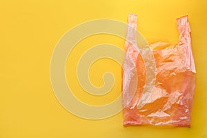 Clear disposable plastic bag on color background.