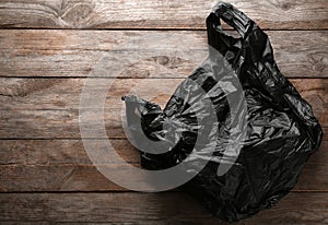 Clear disposable plastic bag on wooden background.