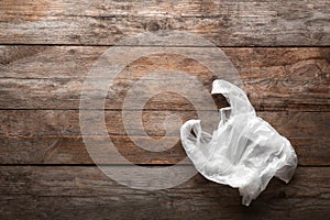 Clear disposable plastic bag on wooden background.