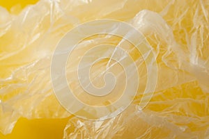 Clear disposable plastic bag on yellow background. Zero waste concept. No palstic. Save planet. Copy space photo