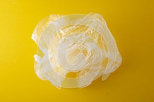 Clear disposable plastic bag on yellow background. Zero waste concept. No palstic. Save planet. Copy space photo