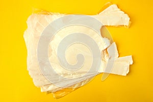 Clear disposable plastic bag on yellow background. Zero waste concept. No plastic