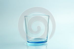 Clear drinking glass isolated on blue background